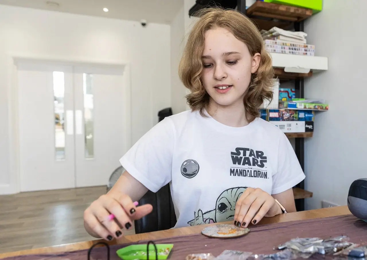 A young person concentrating on a practical craft project at YoungEducation