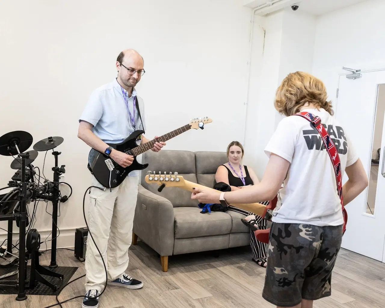 A young person learning an instrument in a music session at YoungEducation