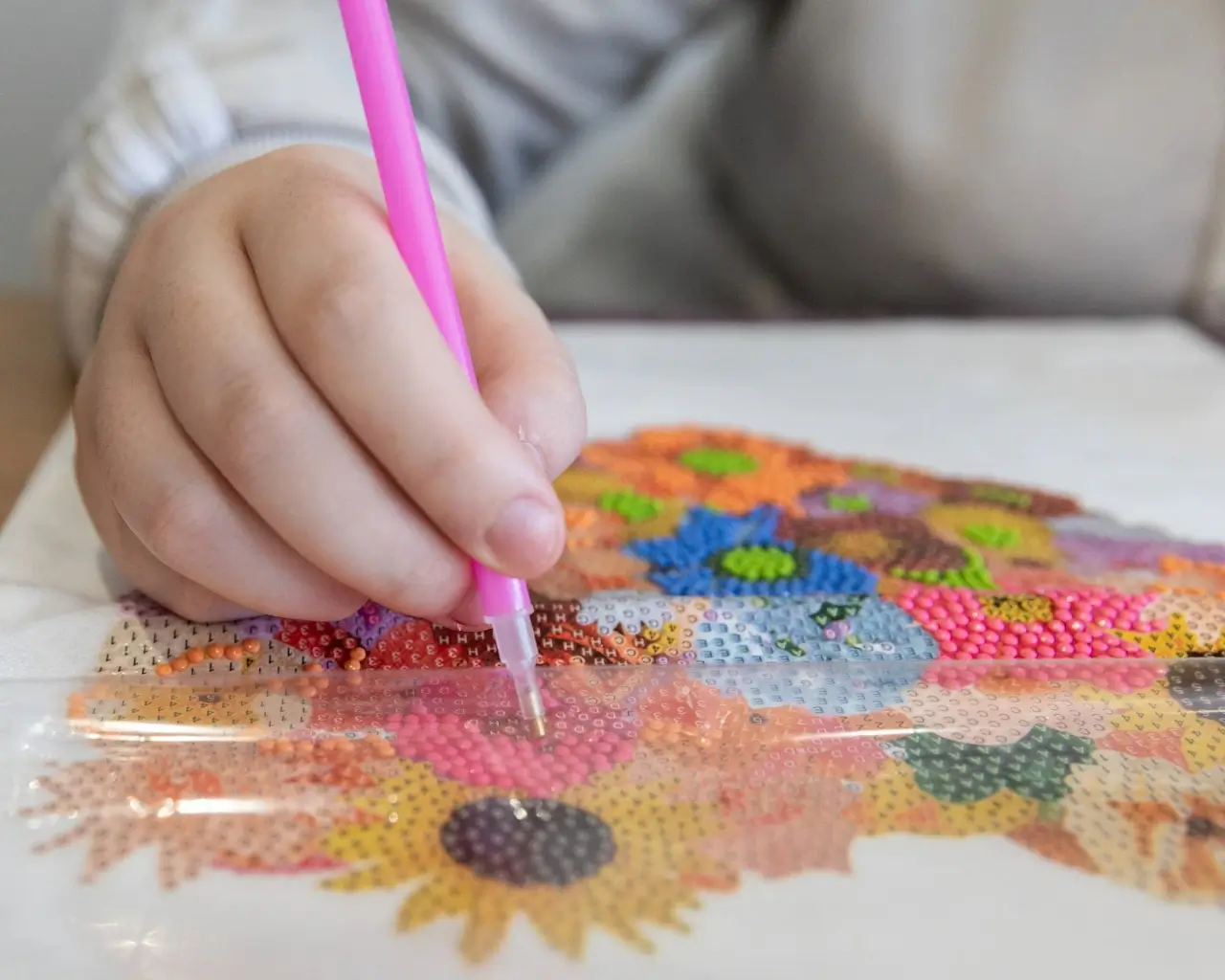 A young person working on a creative arts and crafts project at YoungEducation