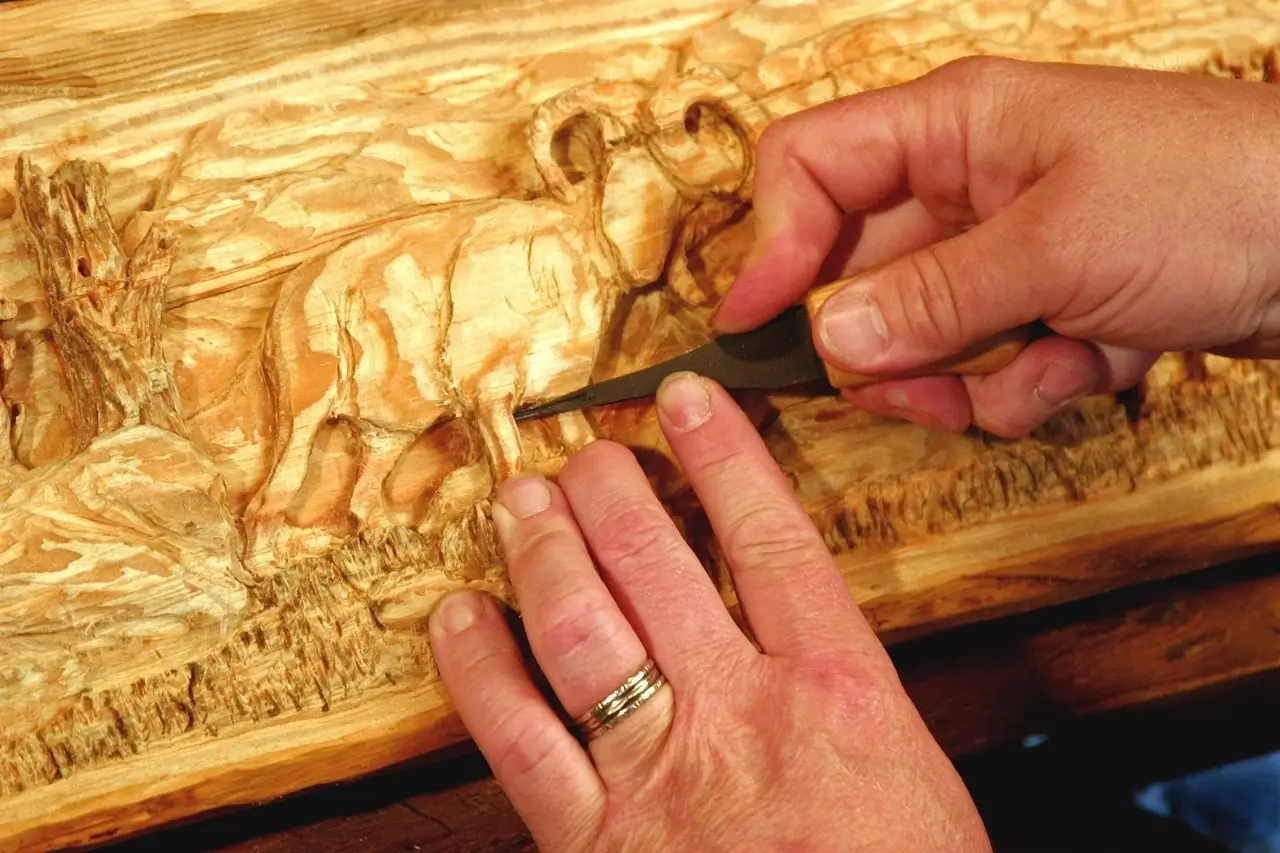 A young person measuring timber during a woodwork and practical design session