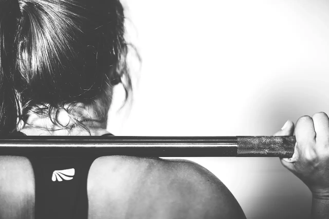 A young person training in the gym with a coach
