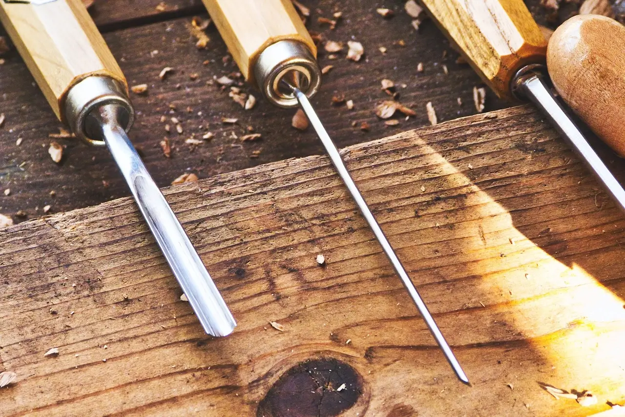 A young person using hand tools during a woodwork and practical design session